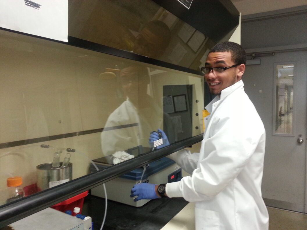 Kendall Dawkins collects a sample from an ozonation process being used to treat pharmaceutical waste