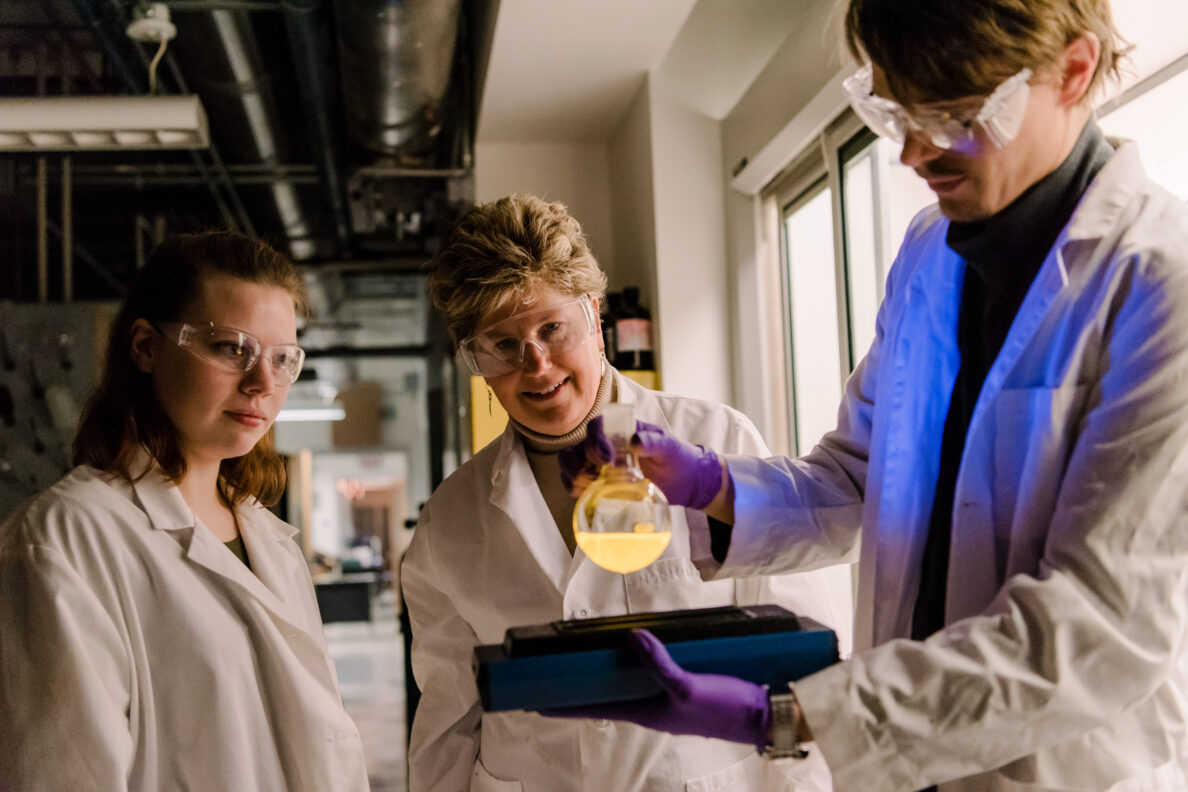 Gabrielle Pozza (left) and Ryan Grant (right) make fluorophores for stimuli-responsive polymers in Prof. Lisa Kelly’s (center) lab