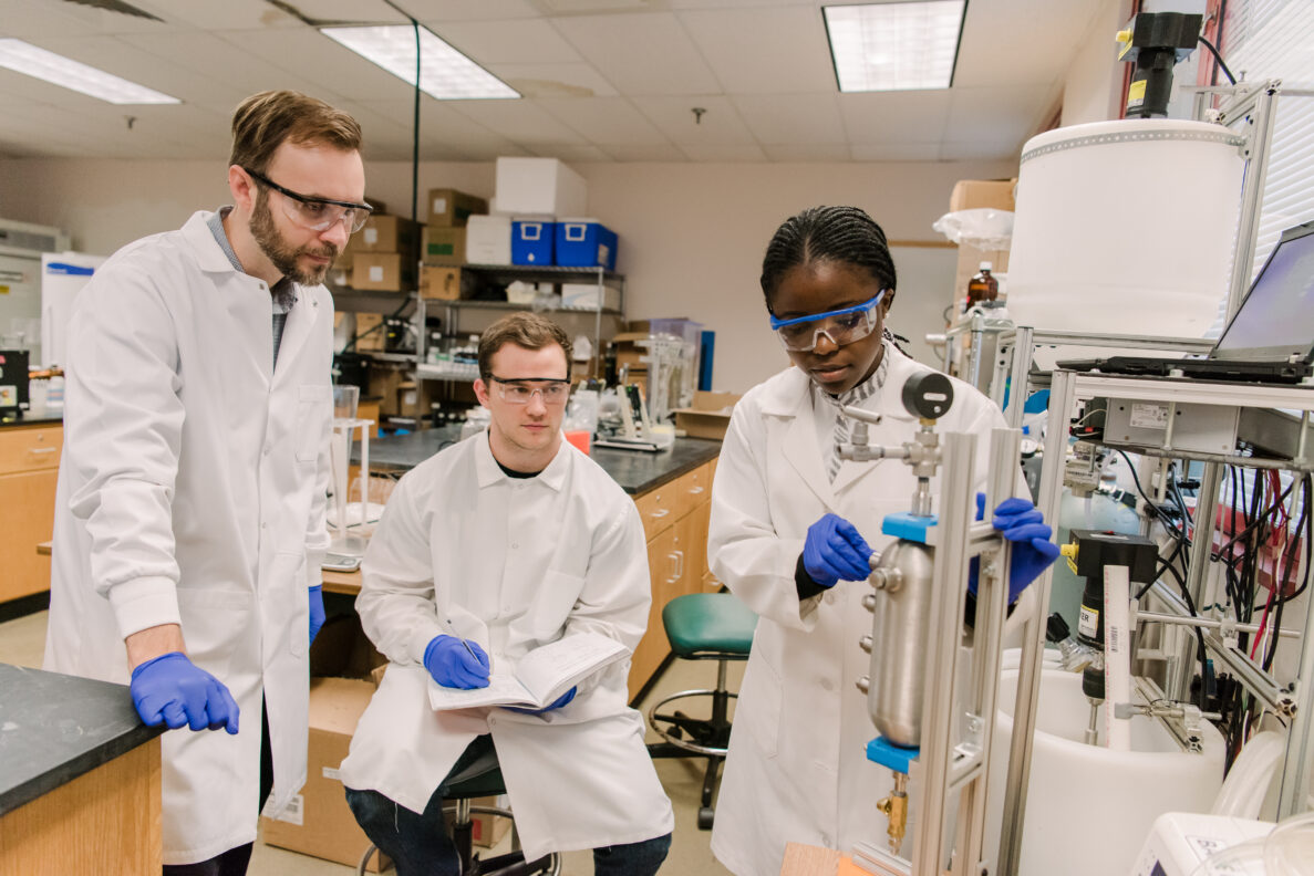 Lee Blaney (left) works with Cameron Sloan (center) and Ouriel Ndalamba (right) to evaluate a new nutrient recovery technologies